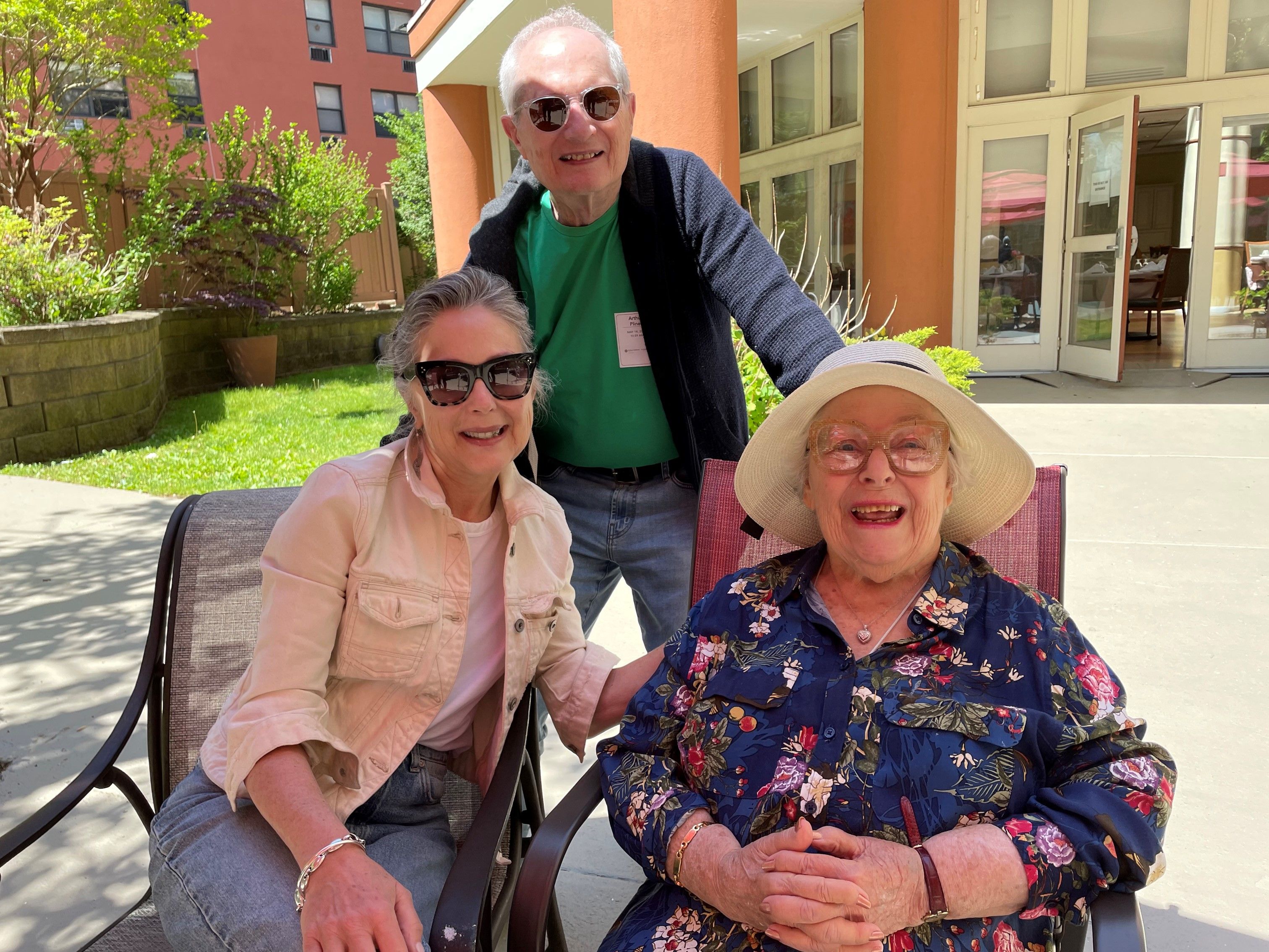 Family enjoys sunshine in assisted living courtyard